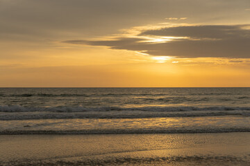 Beautiful sunrise over the ocean with birds soaring through the morning sky. The soft glow of dawn bathes the water and horizon in gentle pastel colors, creating a peaceful and atmospheric coastal sce