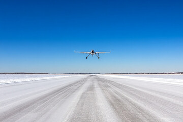 Research drone conducts aerial survey over ice surface in remote Arctic region during clear weather
