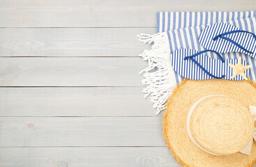 Blue beach accessories on wooden background, top view. Copy space for text