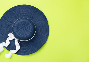 Blue beach hat on color background,top view