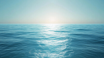 Obraz premium Serene ocean surface with sunlight shimmering across the water under a clear blue sky representing tranquility and freedom.