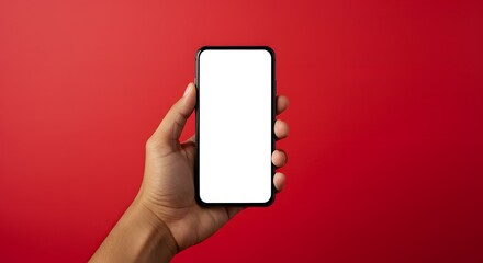 Hand holding smartphone with blank screen on red background