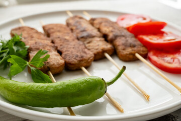 Close-up of traditional Turkish shish kebabs on oval plate