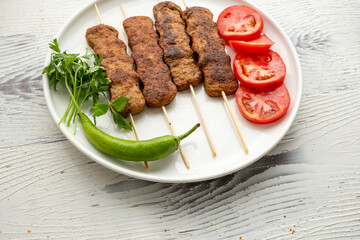 Close-up of traditional Turkish shish kebabs on oval plate