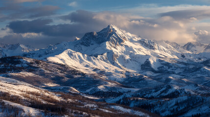 A majestic snow capped mountain range under a cloudy sky with trees in the foreground landscape view