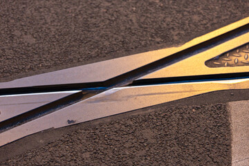 closeup of the tracks of trams cross on the road