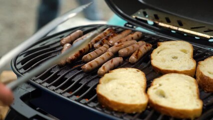Grilling sausages and toasting bread at an outdoor picnic gathering