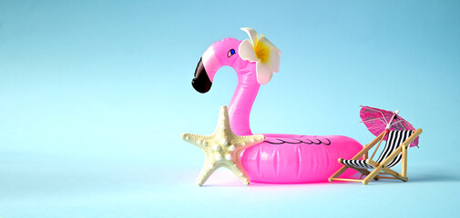 Pink inflatable flamingo with flower and starfish. Summer pool float party idea. Summer concept.