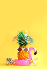 Pink inflatable flamingo and pineapple in sunglasses. Summer pool float party idea. Summer concept.