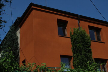 Orange cubic or square family house on blue sky background