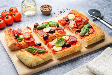 Tasty homemade pizza and ingredients on grey table, closeup