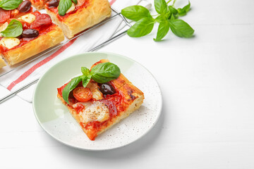 Tasty homemade pizza on white wooden table, above view. Space for text