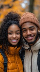 Happy couple smiling warmly, autumn backdrop