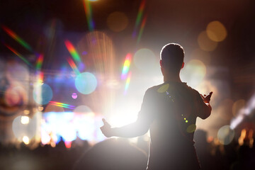 Man performing on stage of open air festival