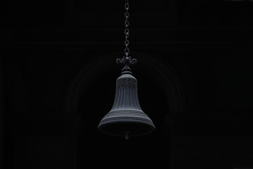 Obraz premium A stunning, gothic bell hanging with chain in a dark background. A timeless design that will bring peace.
