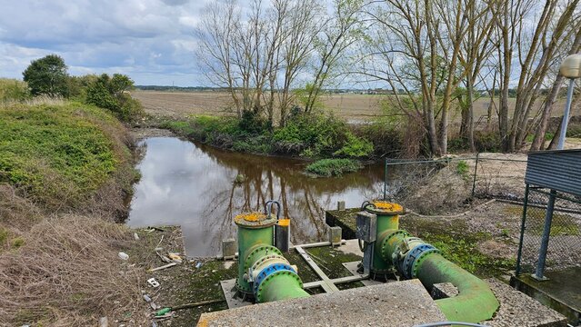 Irrigation Pumping Station with Industrial Pipes near River &ndash; Rural Water Management Infrastructure