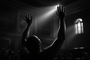 A person raises hands in worship, backlit by a divine beam of light. A silhouette of a person with hands raised in worship, lit up with a beam of light coming down, creating a spiritual atmosphere