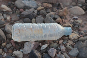 A plastic bottle lying on the ground, Plastic pollution