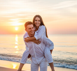 Young cheerful happy couple two friends family man woman in white clothes boyfriend give piggyback ride to joyful, girlfriend sit on back at sunrise over sea beach ocean outdoor seaside in summer day