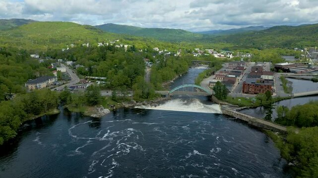 Aerial View of Small Town in Maine with River, Bridge, and Mountain Landscape, drone 4K