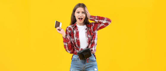Surprised female tourist with documents on color background
