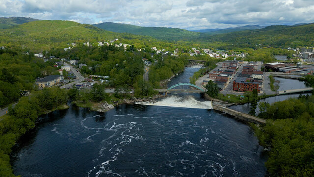 Aerial View of Small Town in Maine with River, Bridge, and Mountain Landscape
