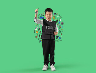 Cute little police officer with handcuffs on green background