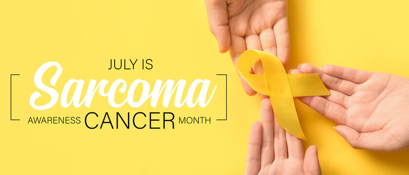 Women holding yellow ribbon on color background, closeup. Sarcoma concept.