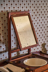 Antique colonial era wash basin with a mirror 