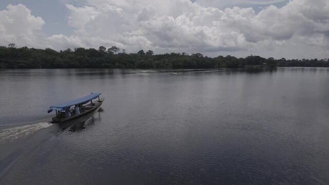 3 August, 2023
Barreirinha, Brazil.
Small boat sails on a river in the Brazilian Amazon. Drone footage.