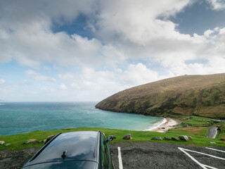 Family car parked in car park with stunning view on Keem beach and bay, county Mayo, Ireland. Irish...