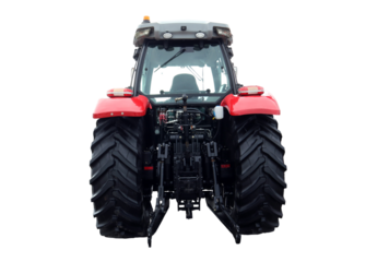 The red farm tractor stands prominently, viewed from the back, highlighting its large tires and agricultural machinery. It is parked in an open field, reflecting a typical day on the farm.