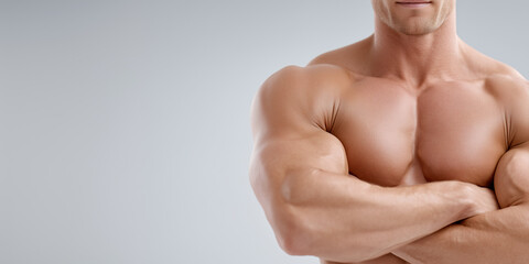 A muscular bodybuilder with arms crossed displaying his toned physique and massive pectoral muscles. A true emblem of health and strength