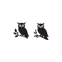 Obraz premium Two Silhouettes of Owls Perched on Branches.Simple, black silhouettes of owls perched on branches.