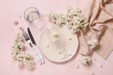 Beautiful table setting with white lilac flowers on pink background