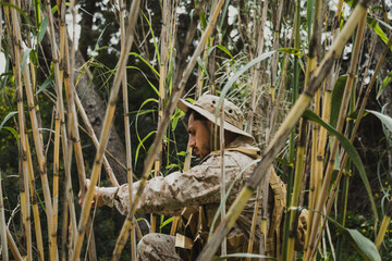 Soldier Camouflaging Himself Inside Bamboo
