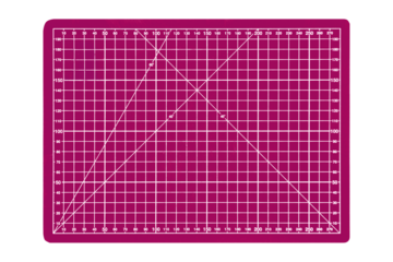 Pink cutting mat with white measurement grid and angle lines is isolated. Craft tool for precise cutting and design work.