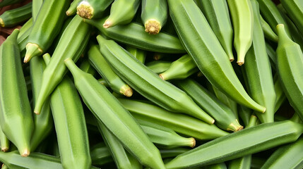Obraz premium Bright green finger okra piled for market closeup view