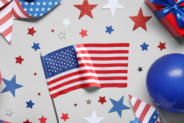 Obraz premium USA flag with stars, gift box and decor on grey background. Independence Day celebration