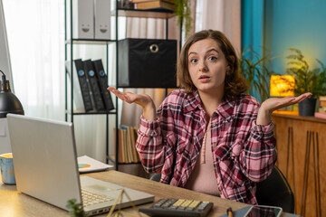 I don't know what to say. Confused businesswoman working on laptop at office table. Freelancer...