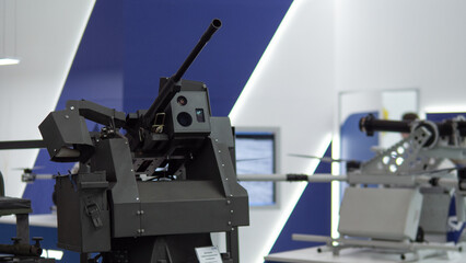 Military Display Features Advanced Gun Technology at a Defense Expo Showcasing Cutting-Edge Warfare Equipment in an Exhibit Hall