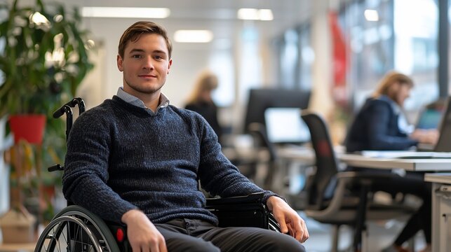 Young man in wheelchair, confident smile, modern office background