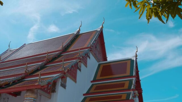 Red tiles with golden serpent-shape chofahs on the picturesque traditional Thai style roof of Wiharn Phra Mongkhon Bophit temple in Ayutthaya