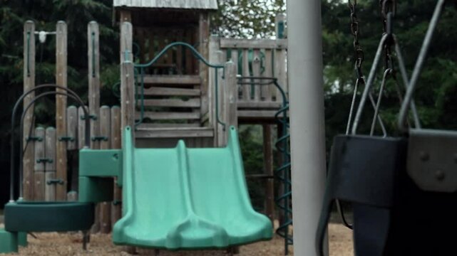 empty swings in children playground park with sad sorrow theme