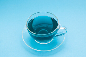 Thai anchan blue tea in the glass cup on the light blue background 