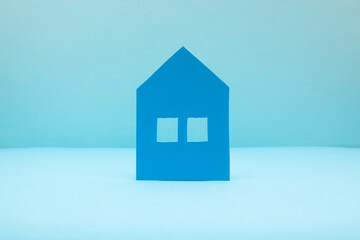 Blue house on light blue background, real estate concept 