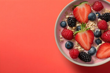 Colorful bowl of yogurt, granola, and berries.