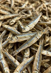 Photo of Dried Brown Fish Pile with Close-Up Texture and Seafood Background