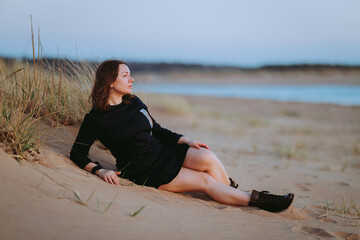 young woman sitting on the beach