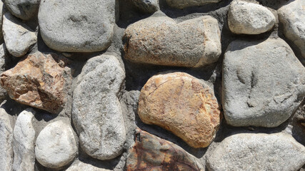 Background or texture of a wall made of old, rough natural eco stone in a modern interior. Eco stone cladding of building facades and home interiors.